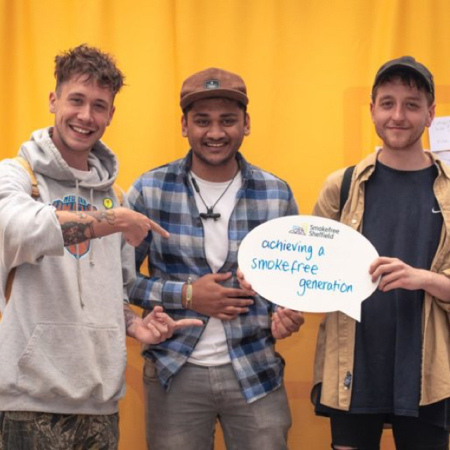 Three young men holding a Smokefree Sheffield sign